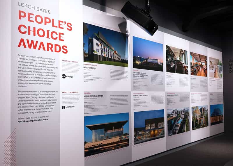 Inside an exhibit space with a wall of images and content